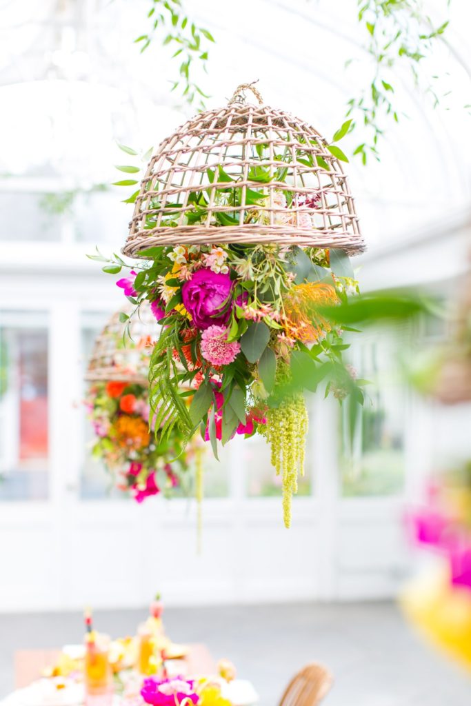 Woven basket with flowers that hang beautifully from a ceiling above