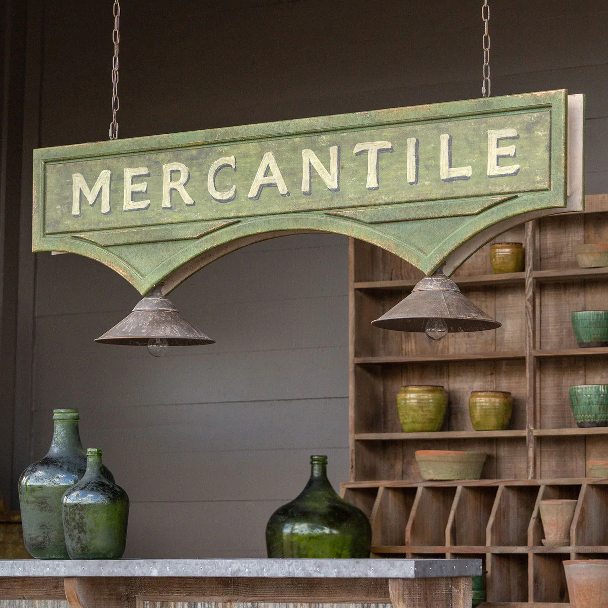 Mercantile sign with lights hanging from a ceiling