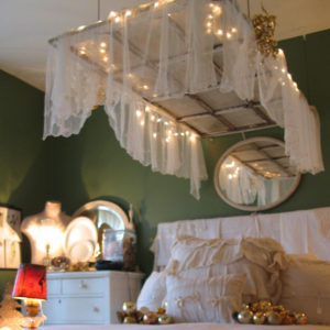 Beautiful bedroom with old chippy door hanging above the bed