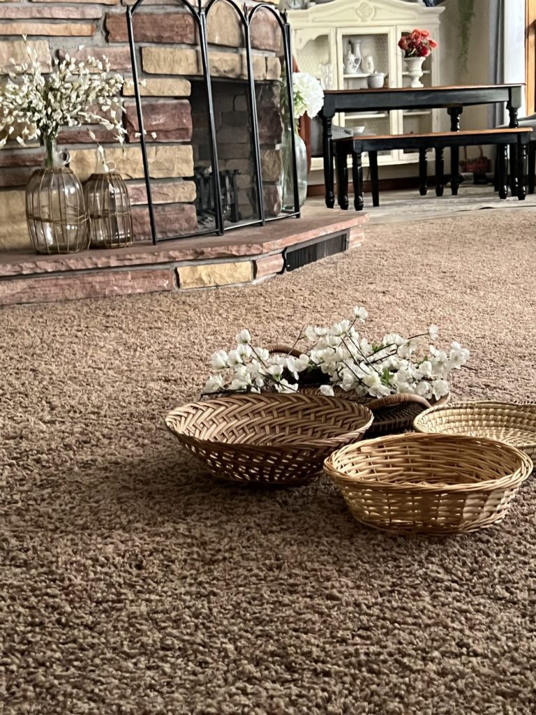 arranging baskets on the floor before nailing them to a wall