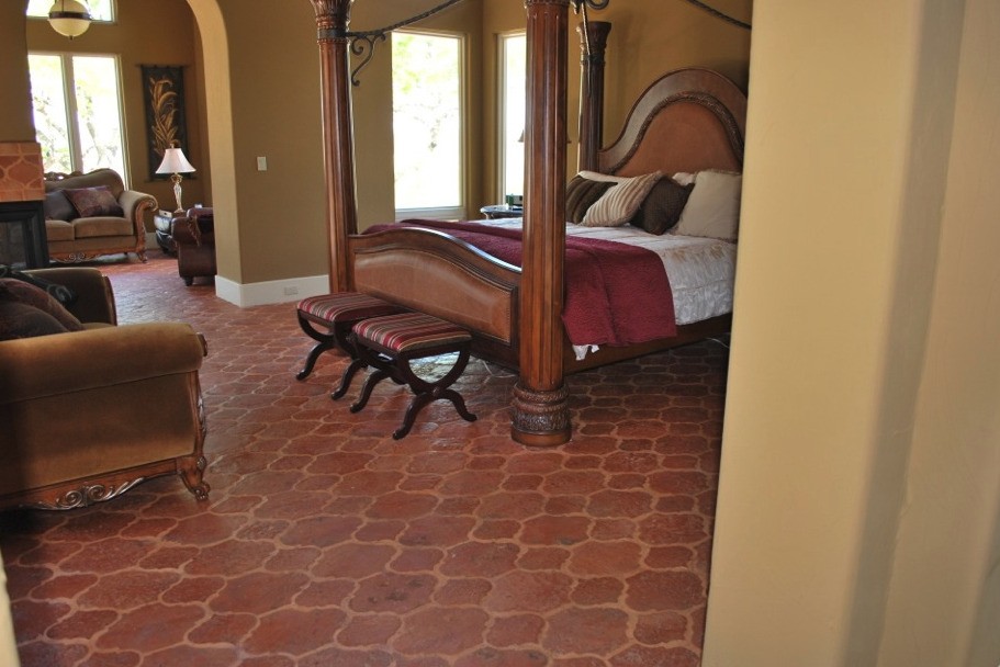a Mexican style bedroom furniture photo with a beautiful tile floor