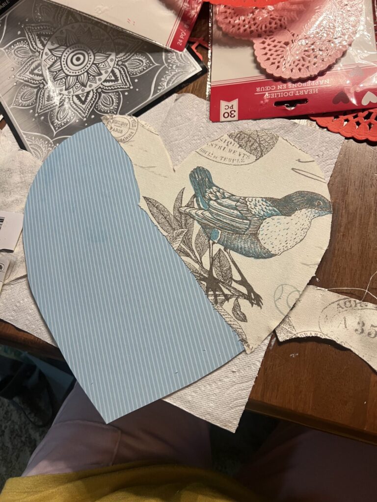 heart shaped valentines door decoration with scrapbooking paper and vintage bird themed fabric across one side
