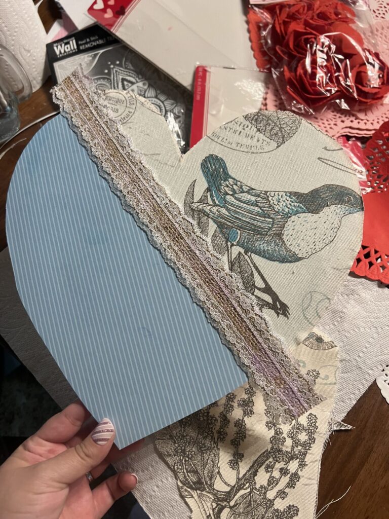 rustic piece of ribbon laying over where fabric and paper meet
