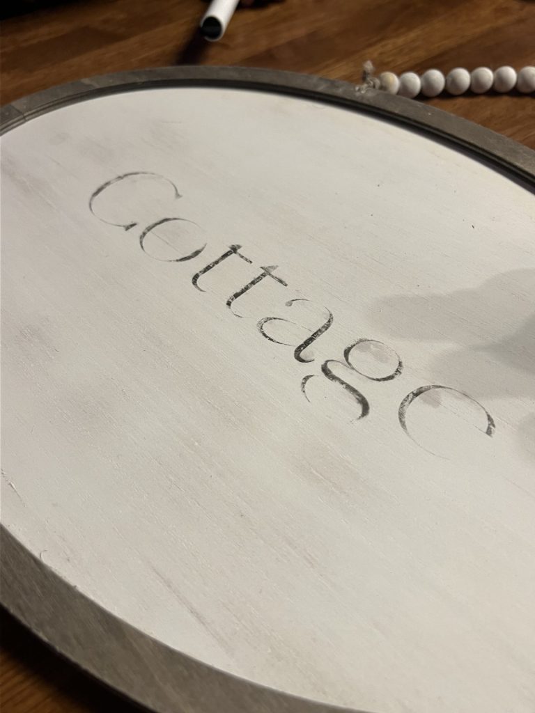 another view of a wood panel with the word "cottage"