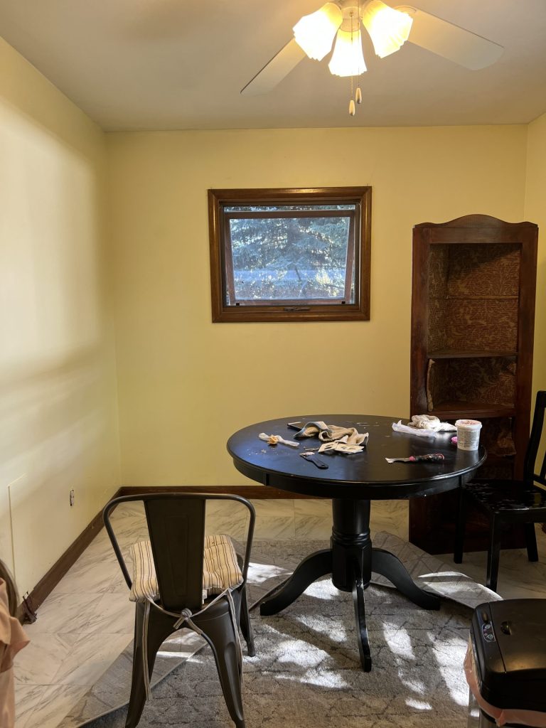 A view of the kitchen nook with yellow painted walls