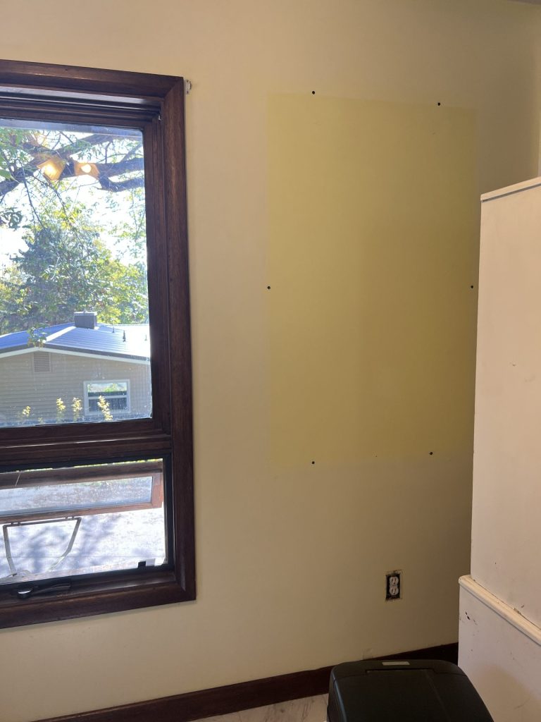 Yellow walls with a space where a large mirror used to be