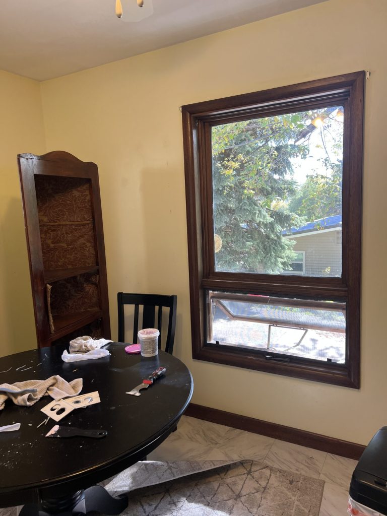 Before view of a farmhouse kitchen nook showing the window