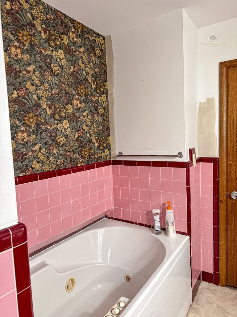 a view of a vintage tile bathroom with a darker brown and beige woodland creature wallpaper