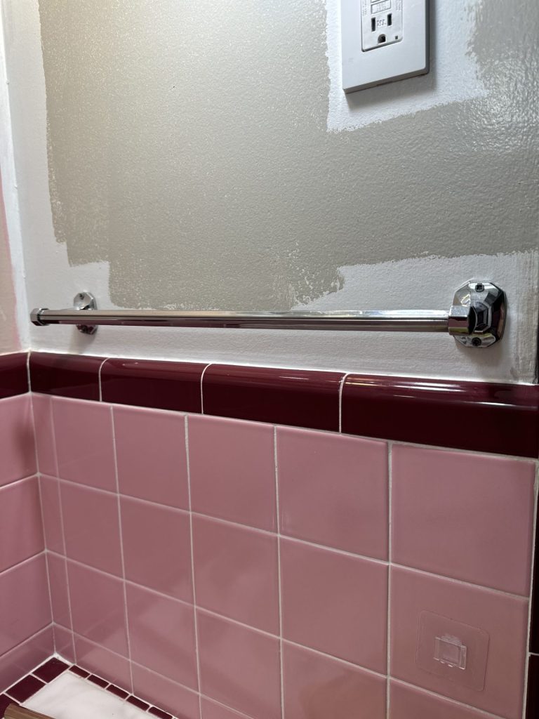 a chrome towel bar in a bathroom