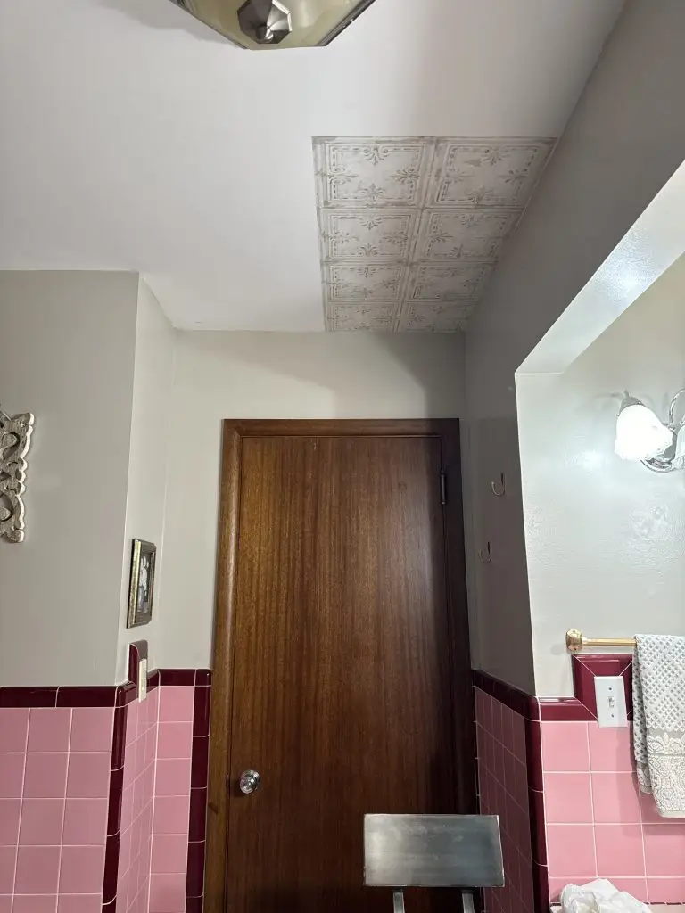 a portioin of the ceiling with wallpaper