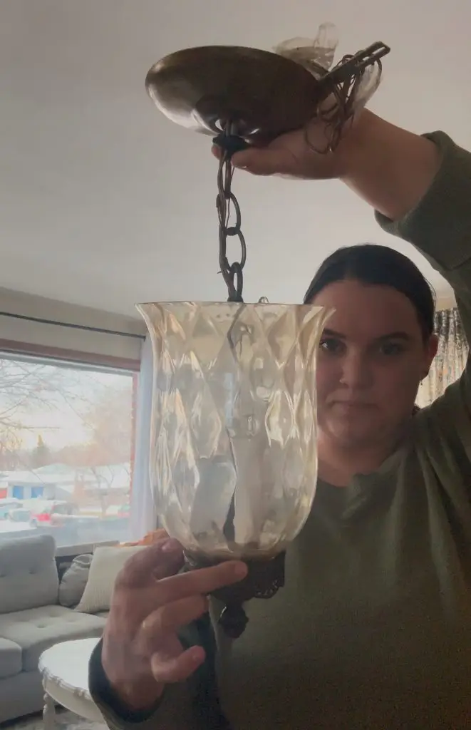 woman holding an antique light