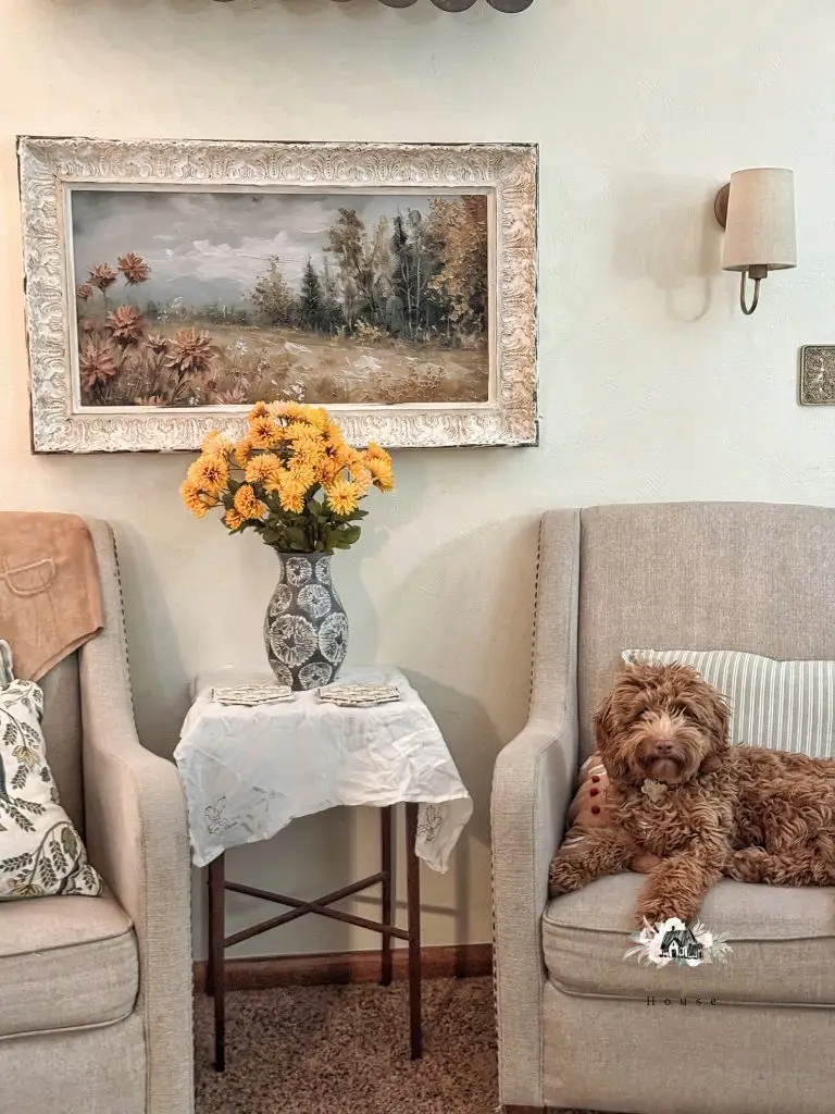 puppy sitting on a chair next to a DIY wall sconce
