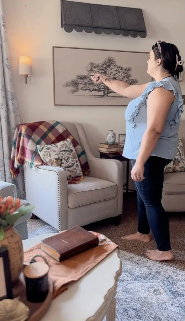 a woman using remote control to turn on the DIY light sconce