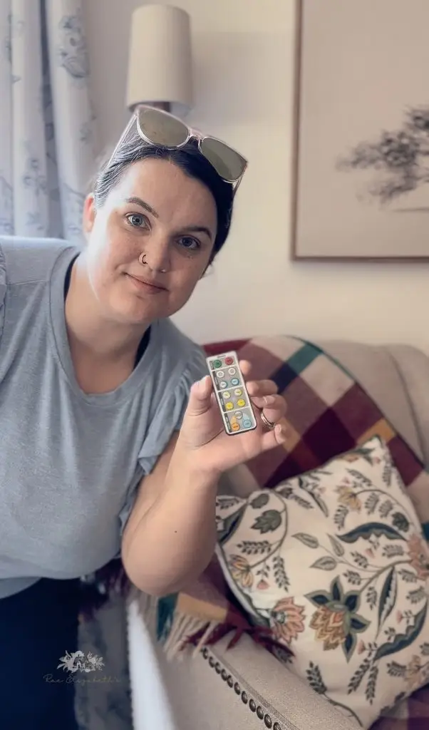 woman holding a small remote control