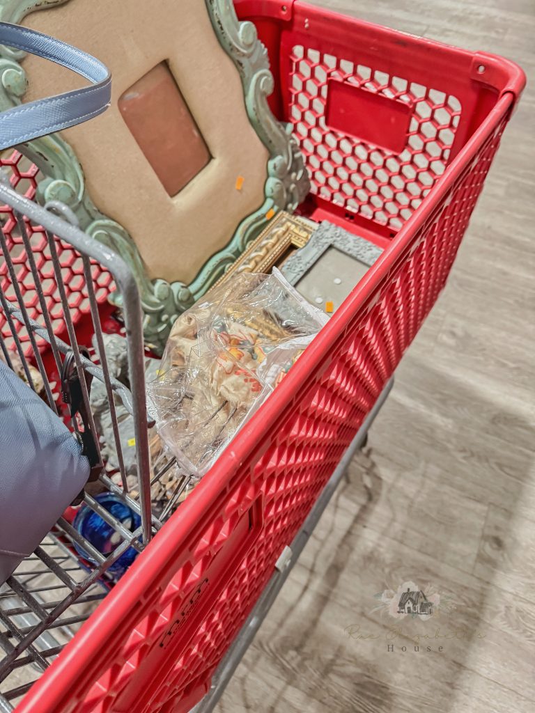 a view of a cart at the thrift store filled with vintage art wall decor