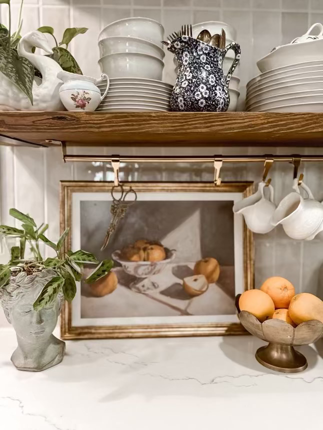 Open kitchen shelving with oranges in a bowl